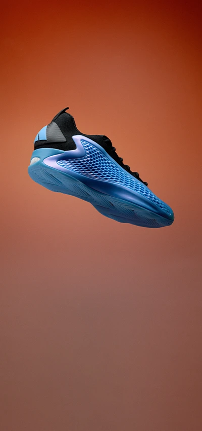 A photo of a multicolored adidas training shoe, flowing in the air. 