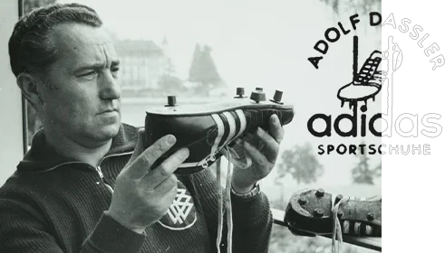 The image shows a person looking closely at a shoe sole. It appears to be an old photo, judging by its quality and style of clothing. The person is repairing shoe soles, possibly for football players.