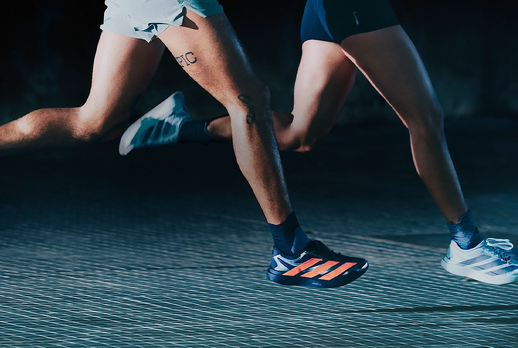 Zwei Personen laufen nebeneinander in adidas Laufschuhen. (Foto)