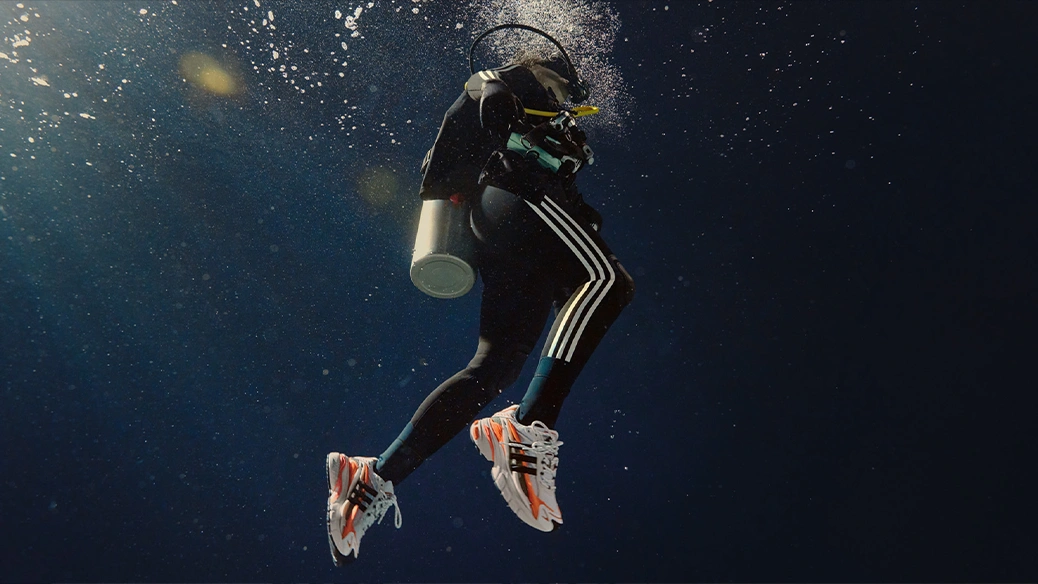 Diver underwater wearing adidas shoes. (Photo)