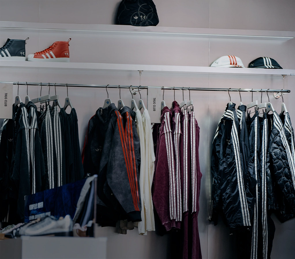 Selection of adidas apparel on a clothing rack. (Photo)