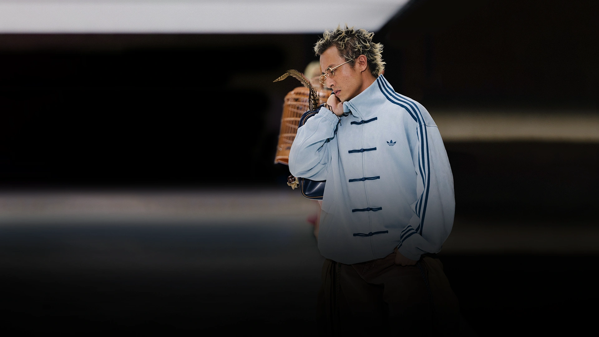 Model wearing an adidas jacket on a runway. (Photo)