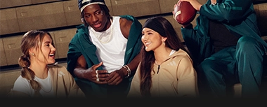 Young adults sitting together wearing adidas sportswear. (Photo)