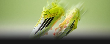 Neon adidas football boots in motion. (Photo)