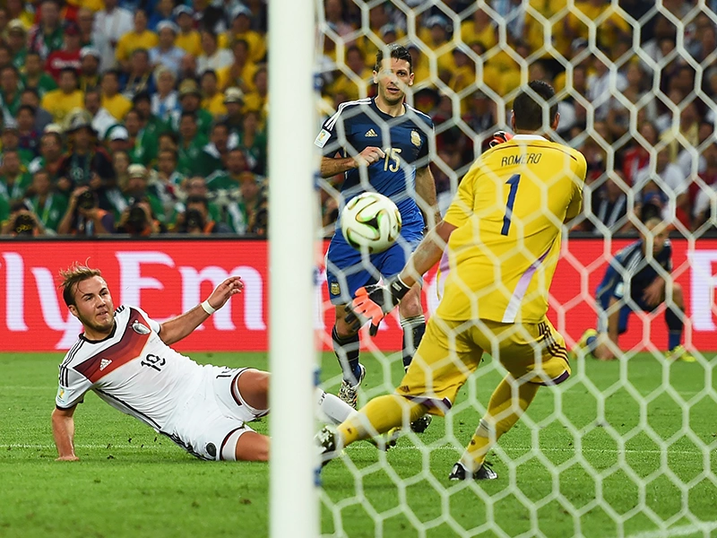 Football match in a stadium: players wearing adidas jerseys during a shot on goal. (Photo)