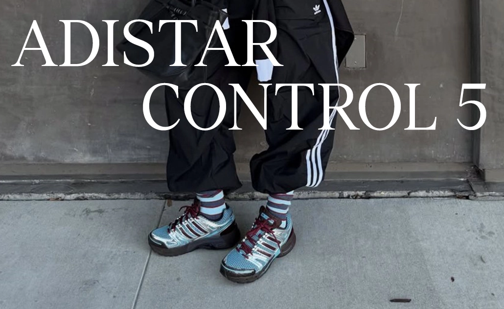 Person wearing adidas sneakers in an urban setting, with the text “Adistar Control 5.” (Photo)